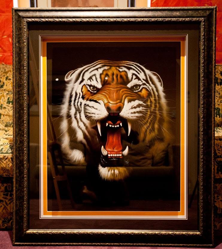 Dramatic painted artwork in an ornate dark frame with a gold inner mat